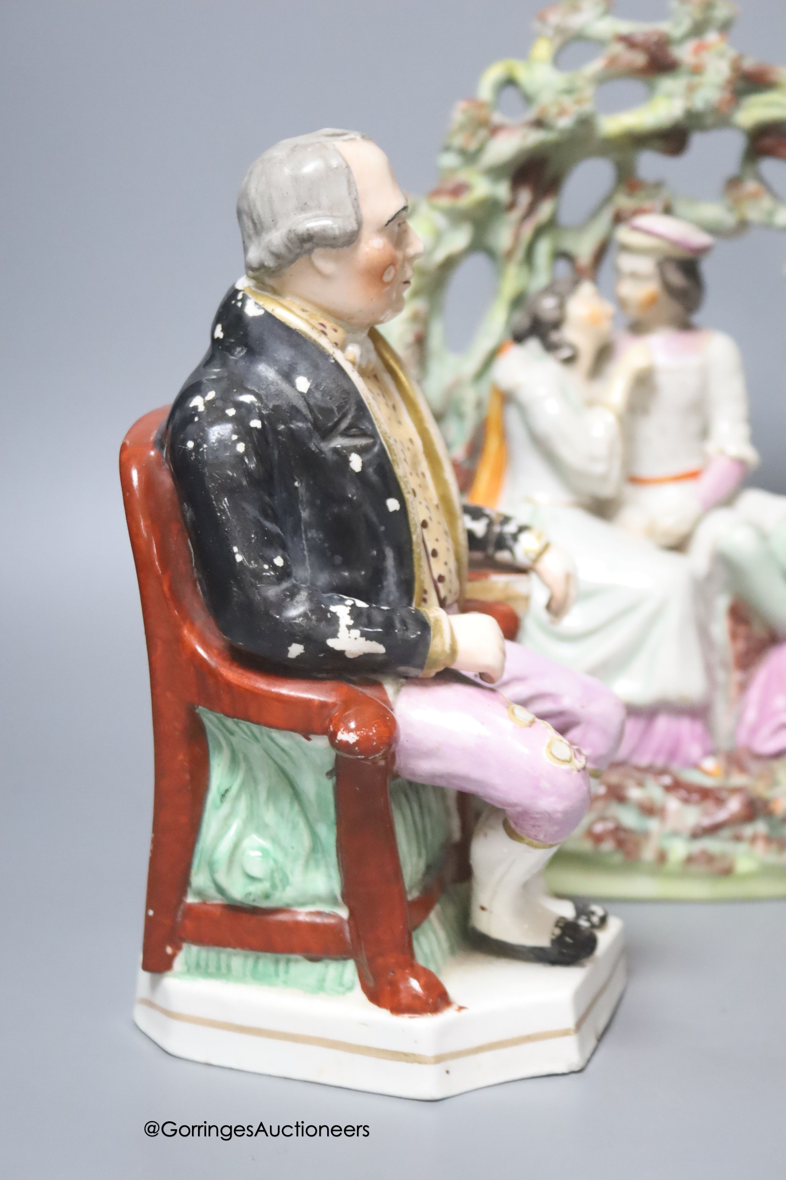 An early 19th century Derby vase, associated cover, a Staffordshire seated gentleman and an arbour group, tallest 25cm